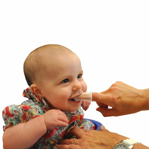 Parent using baby toothbrush and gum massager on baby